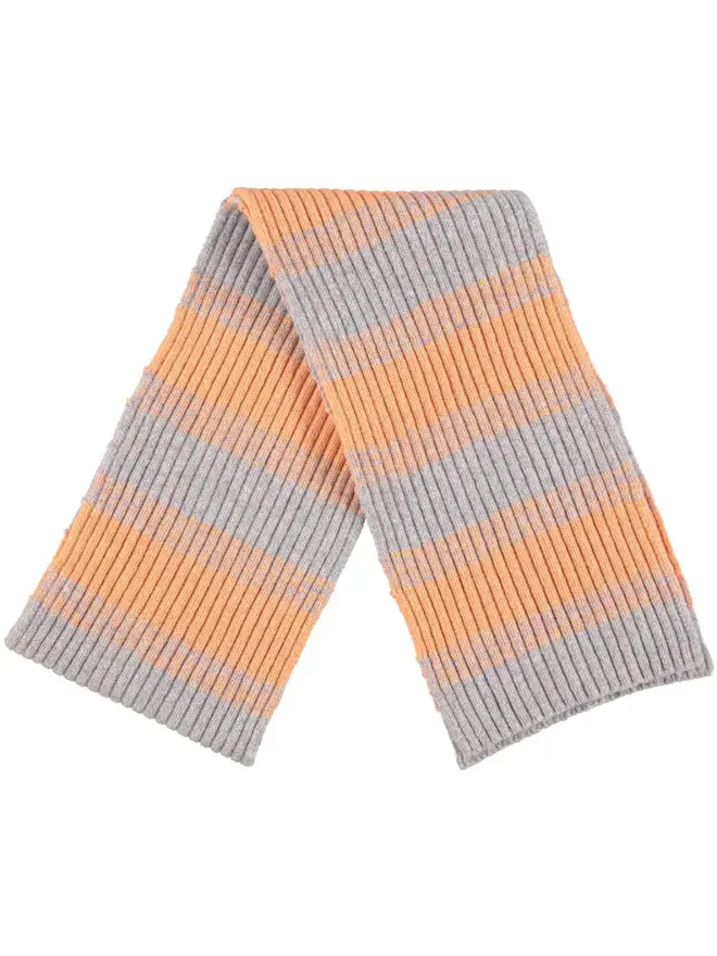 Lambswool Striped Scarf, a colourful striped scarf sitting on a plain white surface. 