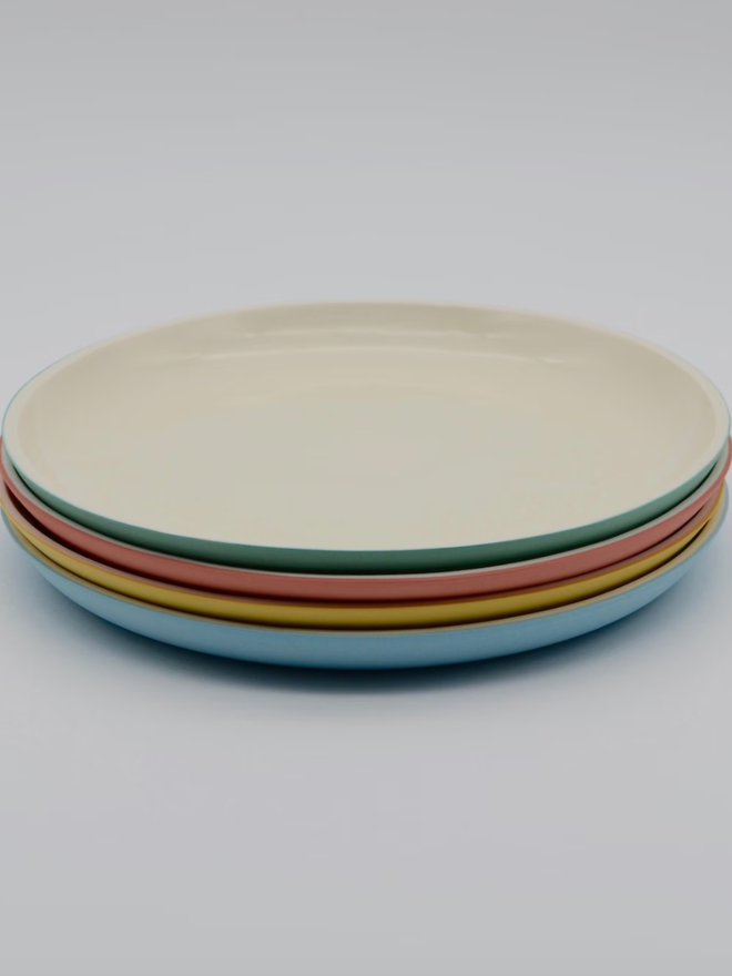 Small Plates. Four plates stacked on top of each other.