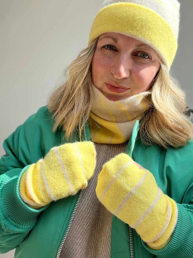 Yellow oatmeal beanie hat, snood and wristwarmers being worn