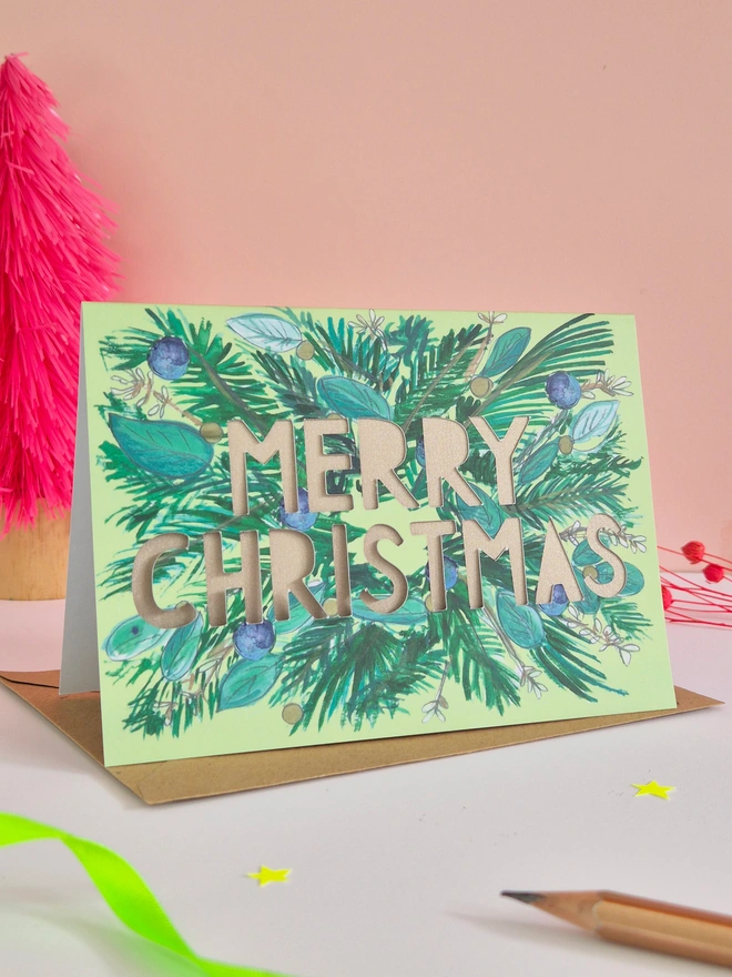 Pine fur and blue berry Christmas card with Merry Christmas text and shimmering mink pearlescent backing paper 