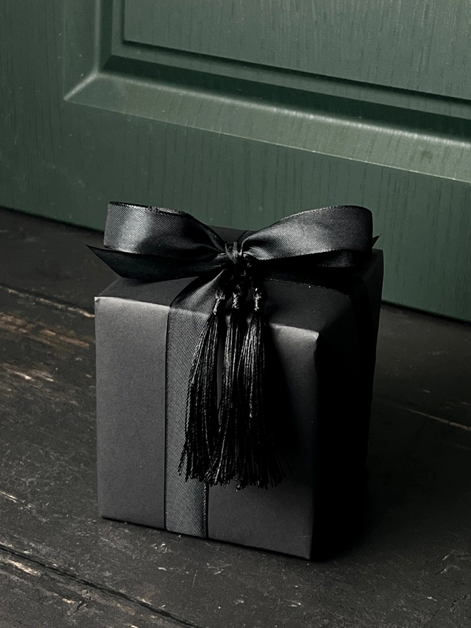 large pumpkin candle. a. black gift box with gift wrap.