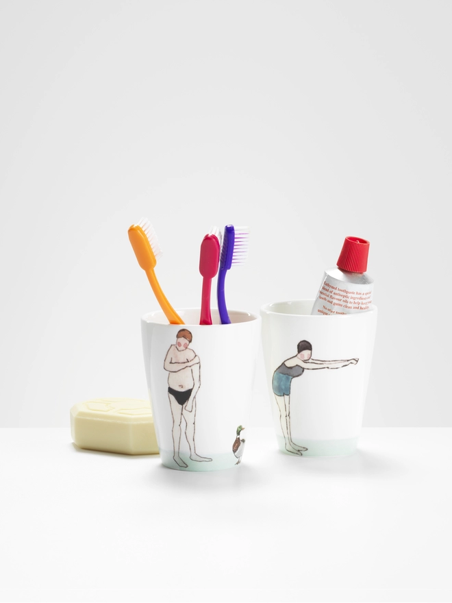 Photo of 2 swimmer beakers with toothbrush props