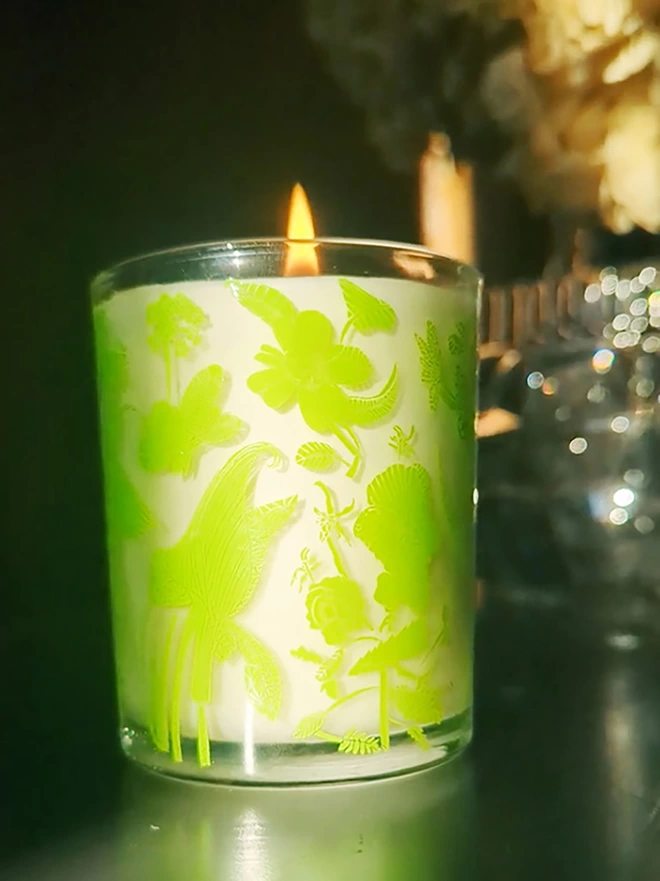 laura's floral, wild fig & grape charity candle in a reusable glass with bright green illustrations