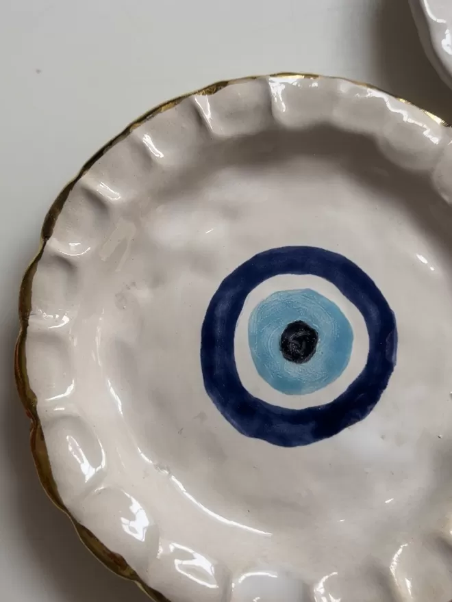 Evil Eye Chunky China Round Dinner Plate with a gold edge. 