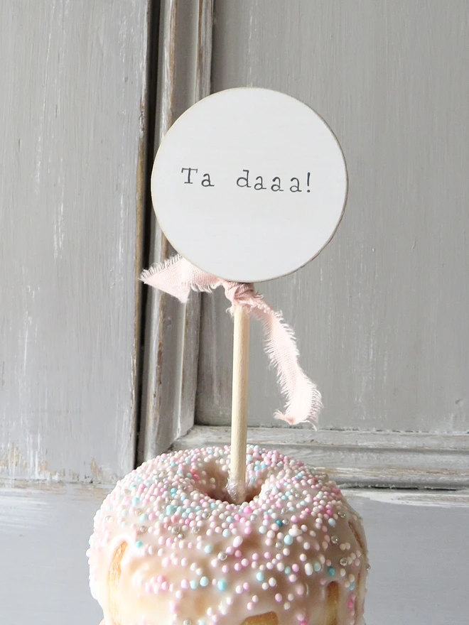 wooden circle shaped cake topper with hand painted message and custom ribbon