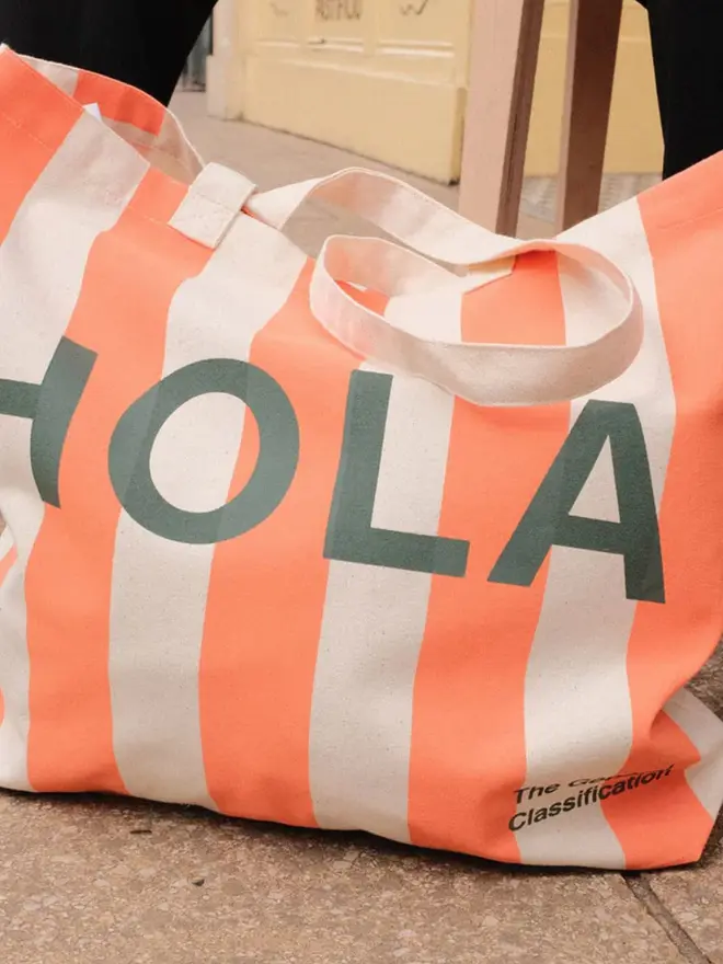 'Hola/Adios' Stripe Tote Bag, against a white background. 