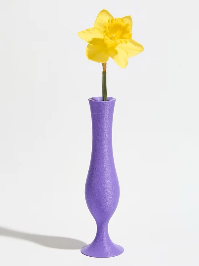 flute shaped 3d printed vase in purple with yellow flower