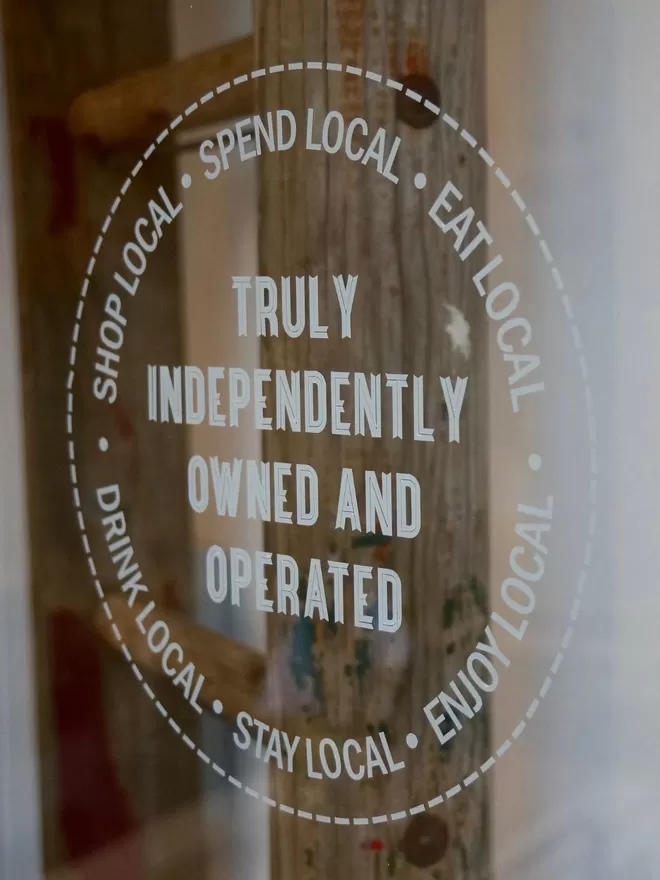 Independently owned and operated sticker seen on a window.