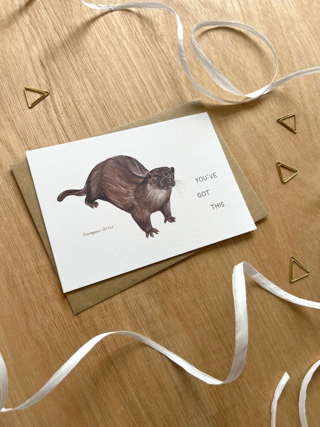 a greetings card featuring an illustration of an Otter with the text “You’ve Got This”