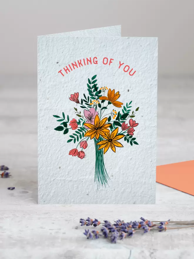 Seed Card with an illustration of a bouquet of flowers with ‘Thinking of You’ written above with a sprig of Lavender placed in the foreground of the image