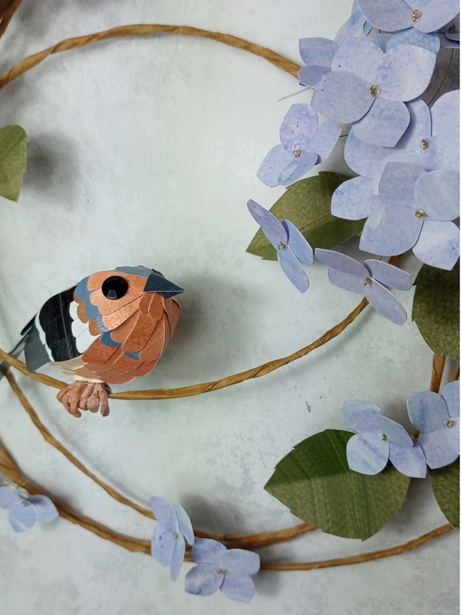 Close up of a chaffinch and hydrangea paper sculpture.