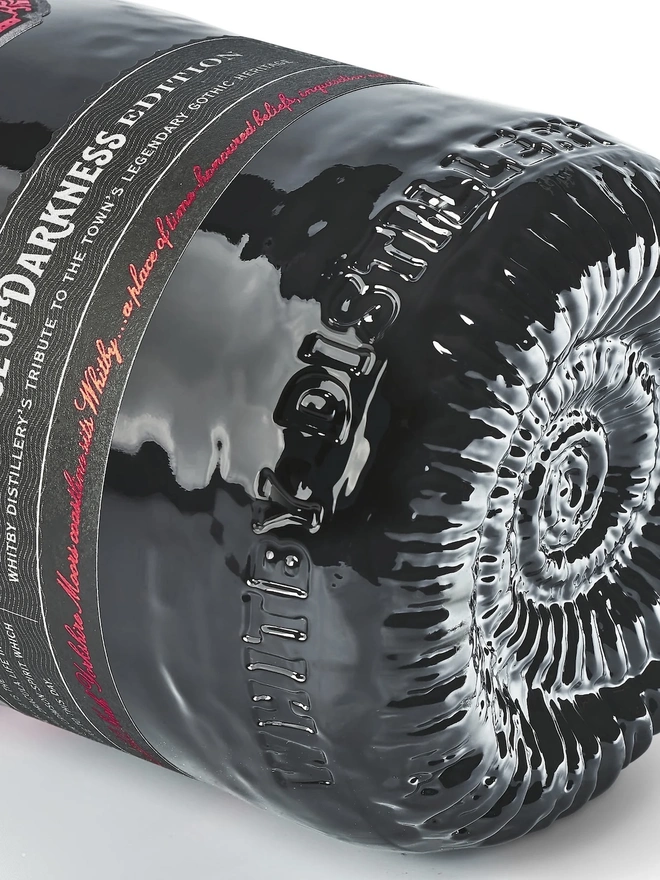 Prince Of Darkness Gin, a bottle of gin sitting on a plain white surface. 