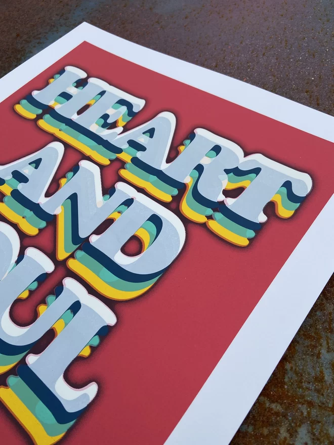 "Heart & Soul" Hand Pulled Screen Print on a red background with rainbow printed typography that says heart and soul 