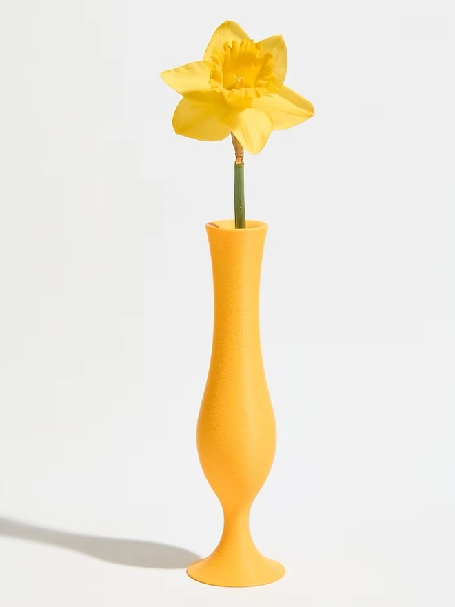 flute shaped yellow 3d printed vase with yellow flower