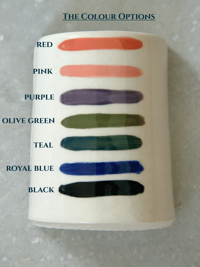 Coloured stripes painted onto stoneware pottery with the name of each colour written next to the stripe.