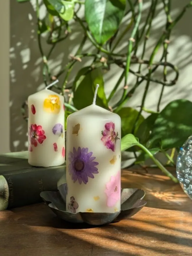 Handmade pillar Candles with Pressed Flower on table