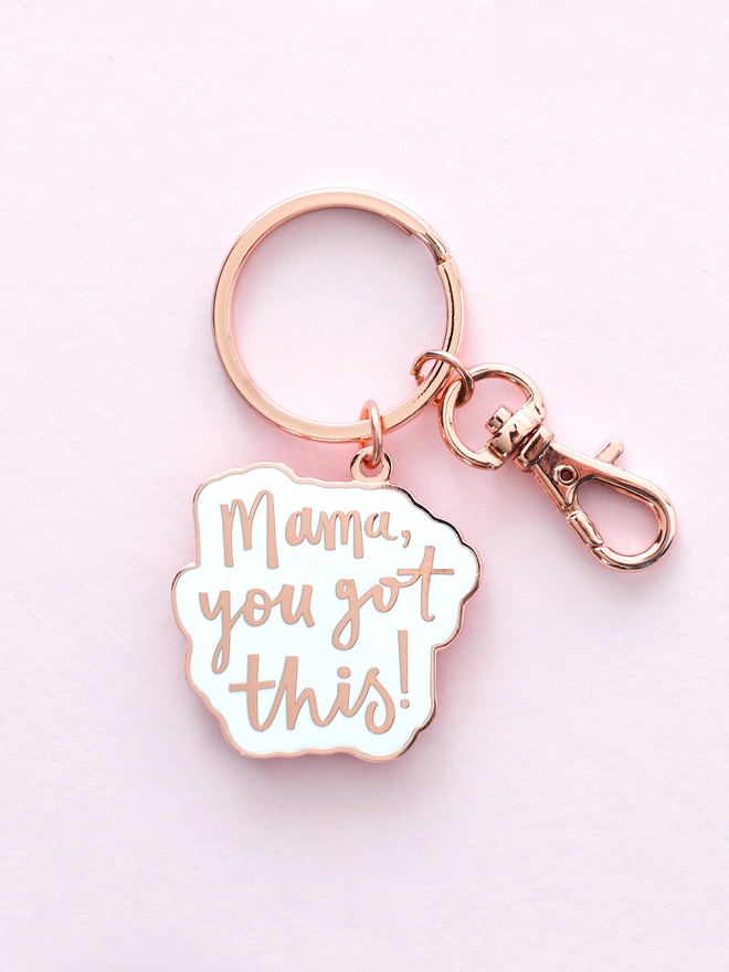 Mama you got this! enamel keyring laying on a pink backdrop
