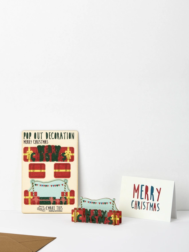 Christmas presents decoration and Merry Christmas card and brown kraft envelope on a white background