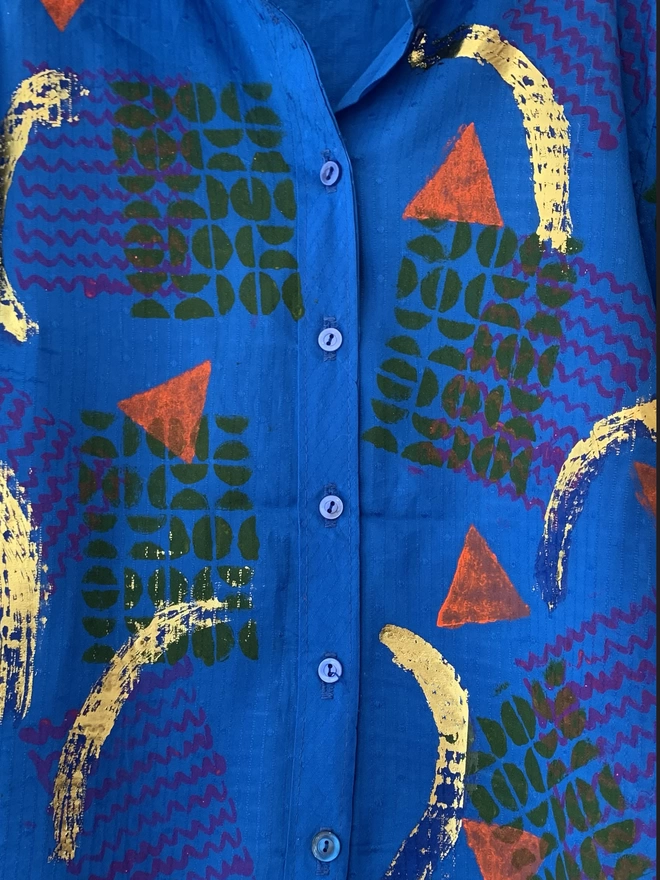 Close up of shirt with patterns and metallic foil
