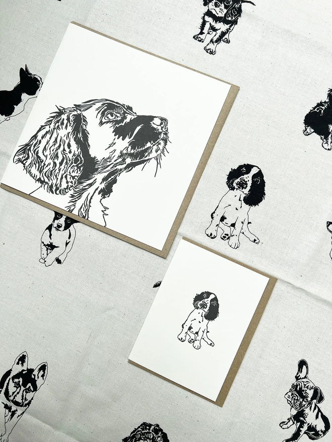Our springer cards loving on our puppy teatowel