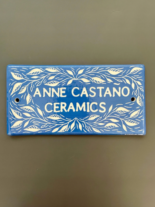 Handmade Ceramic House Plaque with Leaves. A house plaque in blue.