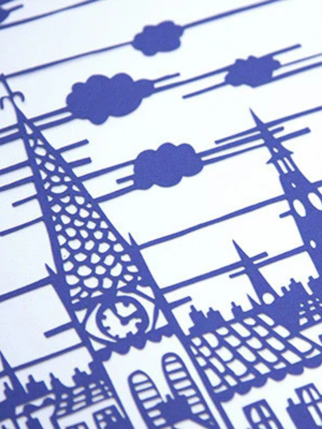 'We promise to keep the child safe' blue lasercut. Closeup of intricate blue lasercut artwork featuring a church and surrounding buildings.