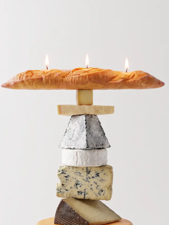 Baguette candle on blocks of cheese