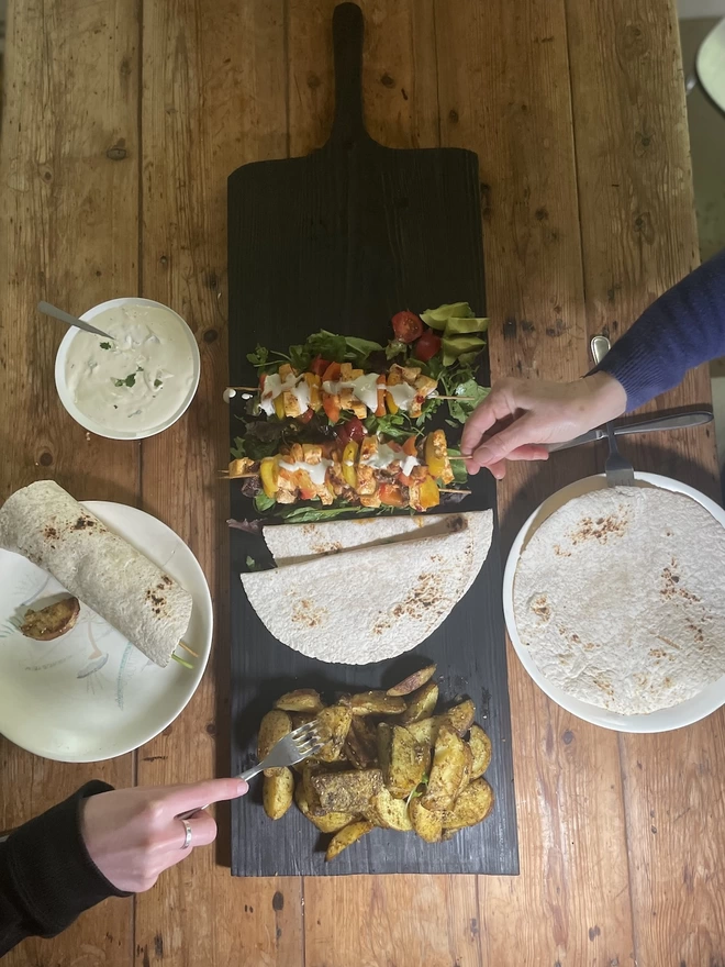 Long Charred Black Serving Board With Food