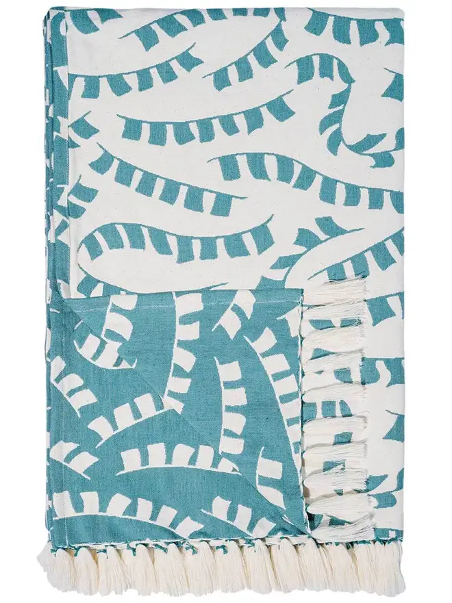 Teal Prayer Flag Woven Throw, a blue throw set on a plain white surface. 