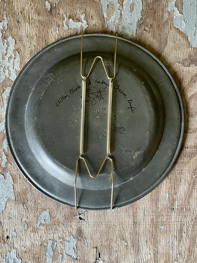 plate hanger on pewter plate