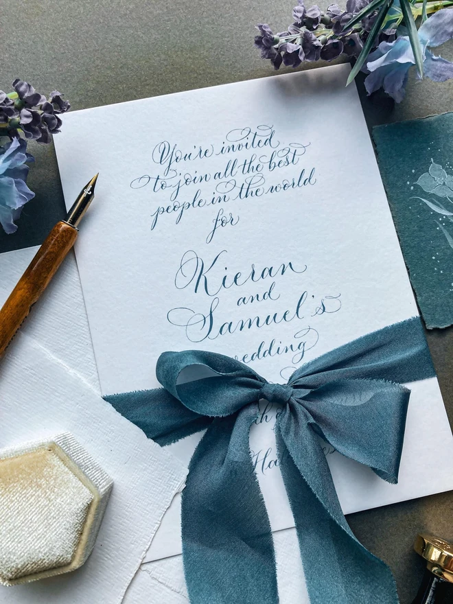 bespoke calligraphy wedding invitations. white paper invitations with black calligraphy.
