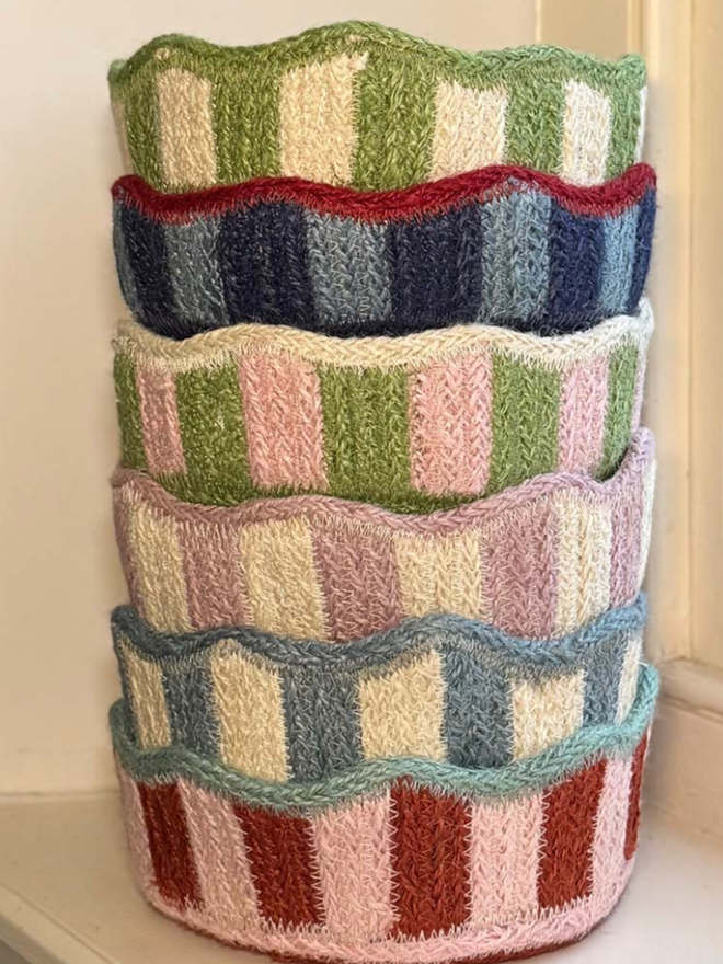 All 6 colours variations of the scalloped mini jute basket stacked on top of one another