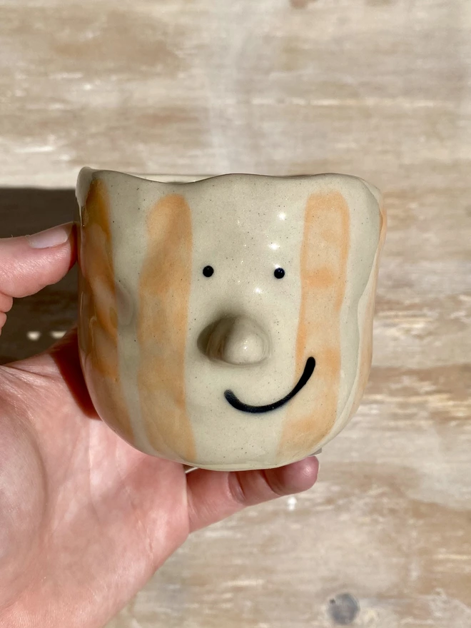 orange stripe pot - held