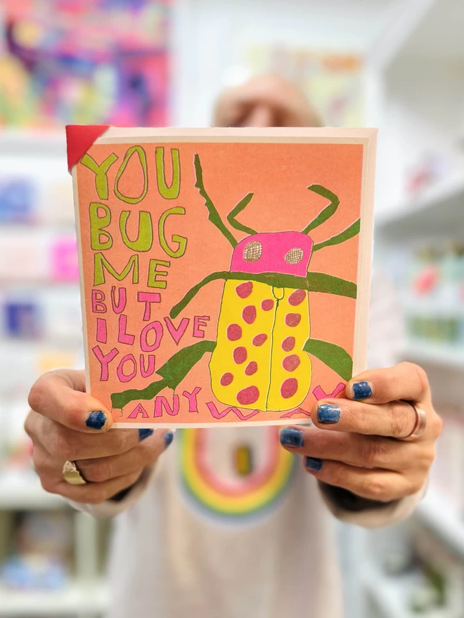 A bright & colourful humorous card featuring a bug with the words You Bug Me But I Love You Anyway 