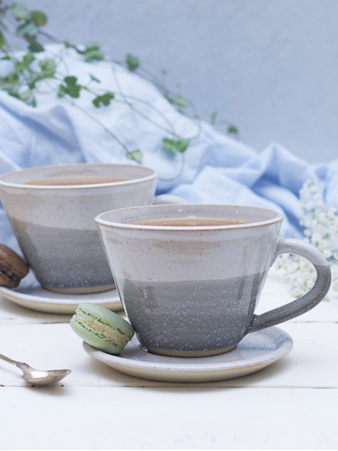 grey and white ceramic mug and saucer 