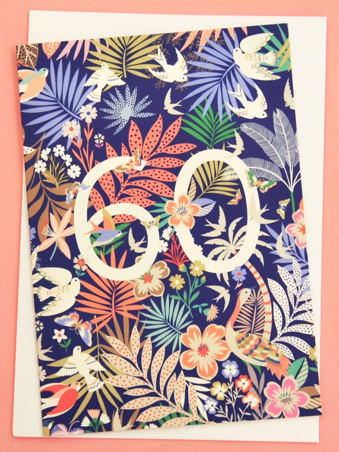 purple birthday card with floral and plant designs, with off white "60" 