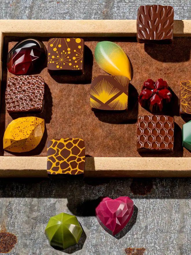 colourful bonbons close up - pink heart, green lime and square pralines 