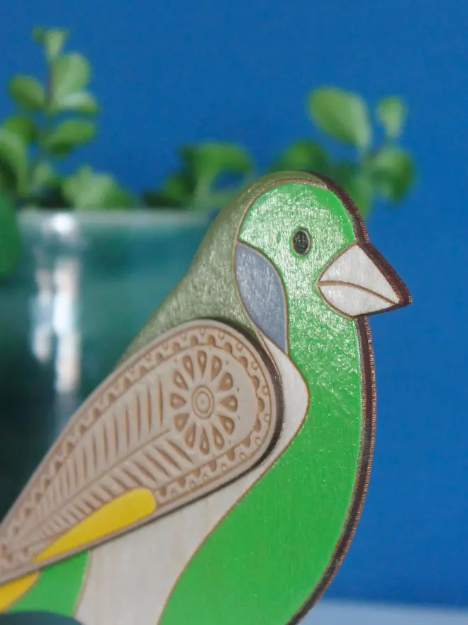 Standing Wooden Greenfinch, green wooden bird standing on a platform. 