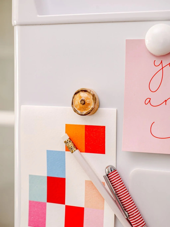 ceramic pastry magnets. a ceramic scotch pie magnet on a fridge door.