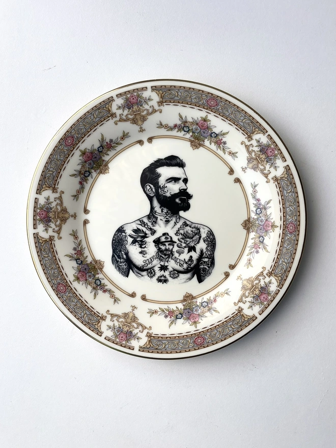 a vintage plate with ornate border, within the centre i have printed the vintage style image of a victorian tattooed sailor man