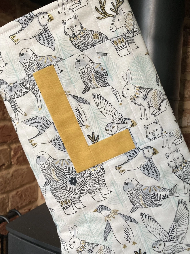 Cooper and Fred Personalised Quilted Stocking in Arctic Animals Print with Mustard letter L