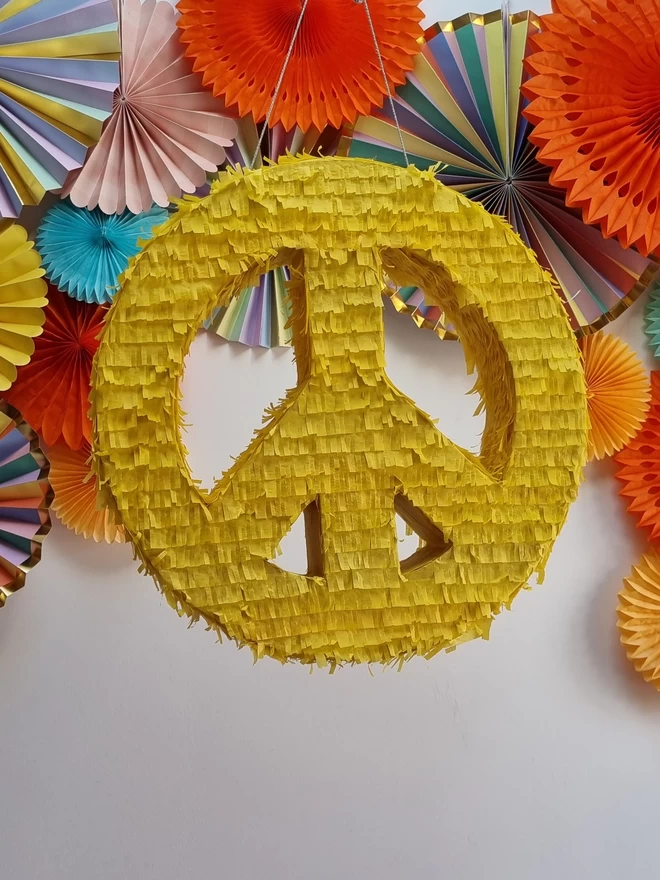 yellow peace and love pinata for 60th theme party by pinyatay