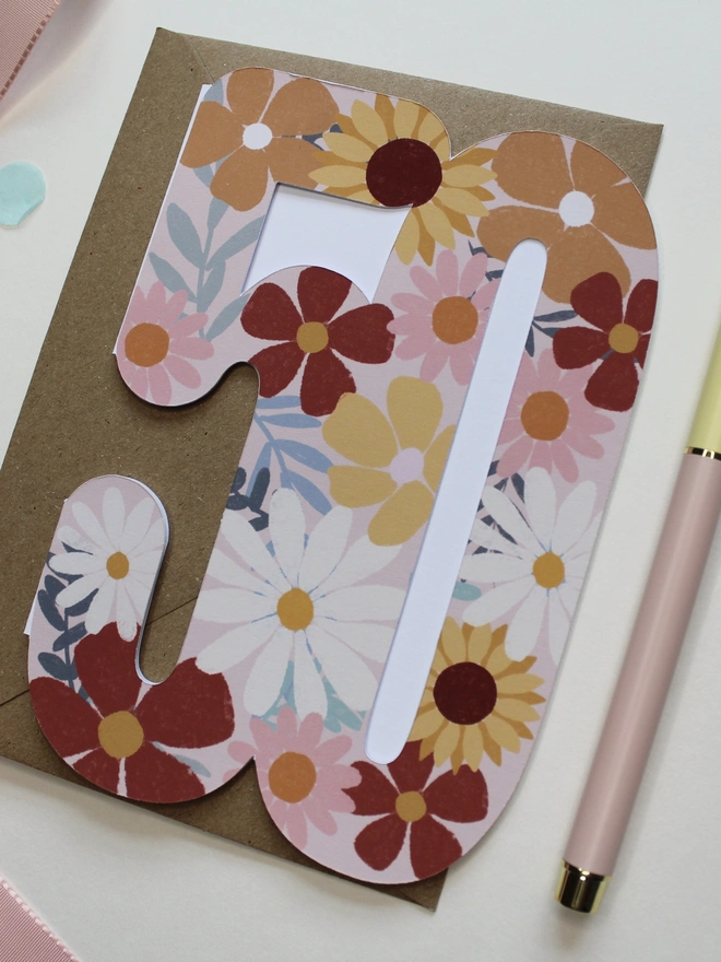 floral 50th birthday card. card shaped like 50 decorated with colourful flowers.
