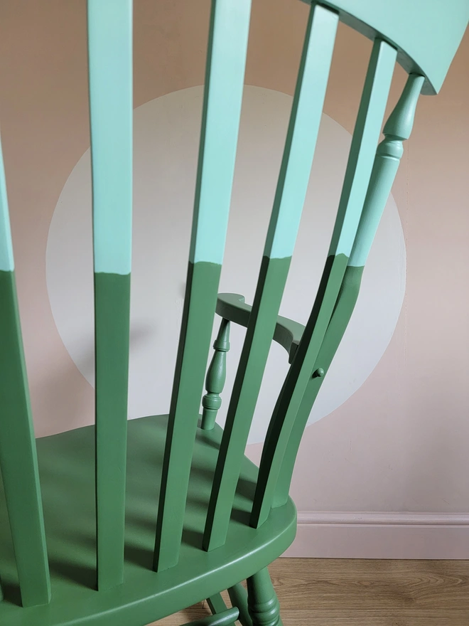 Close up of the back of chair spindles painted green and mint