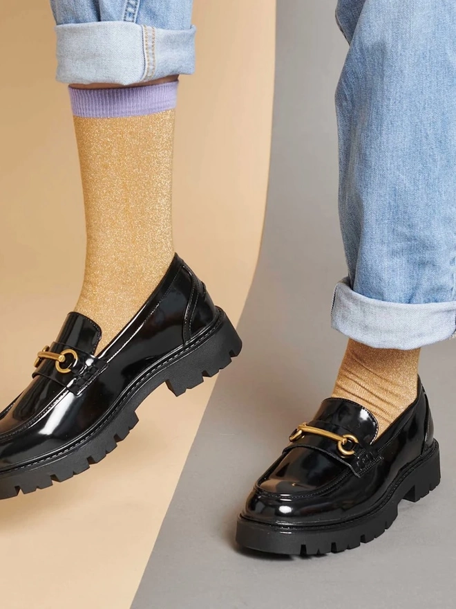 Women's Organic Cotton Ankle Socks Packs (Sets Of 3), a person wearing a pair of colourful patterned socks. 