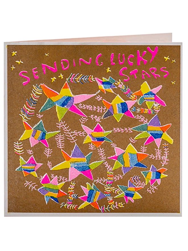 A good luck card with stars in pinks, yellows, blues on gold with the words Sending Lucky Stars
