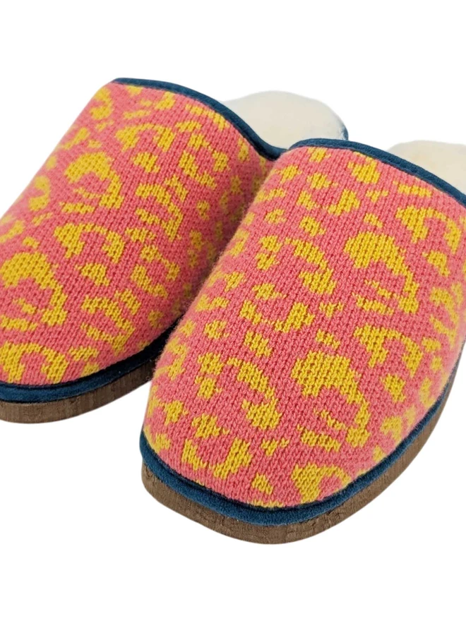 Lambswool & Sheepskin Slippers, a pair of colourful lambswool and sheepskin slippers sitting on a plain white surface. 