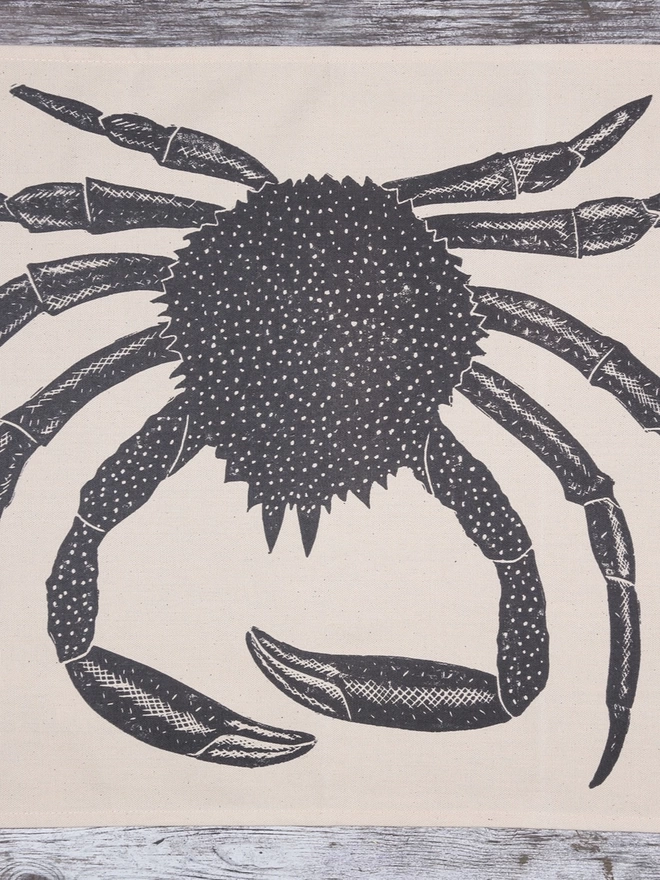 Picture of a tea towel with an image of a spider crab, taken from an original lino print