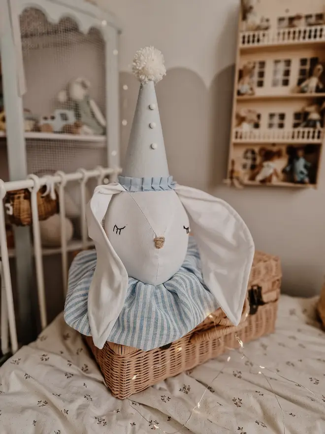 Rabbit Head Wall Mount, a cotton rabbit head wall decoration in a child's bedroom accompanied by other bedroom accessories. 