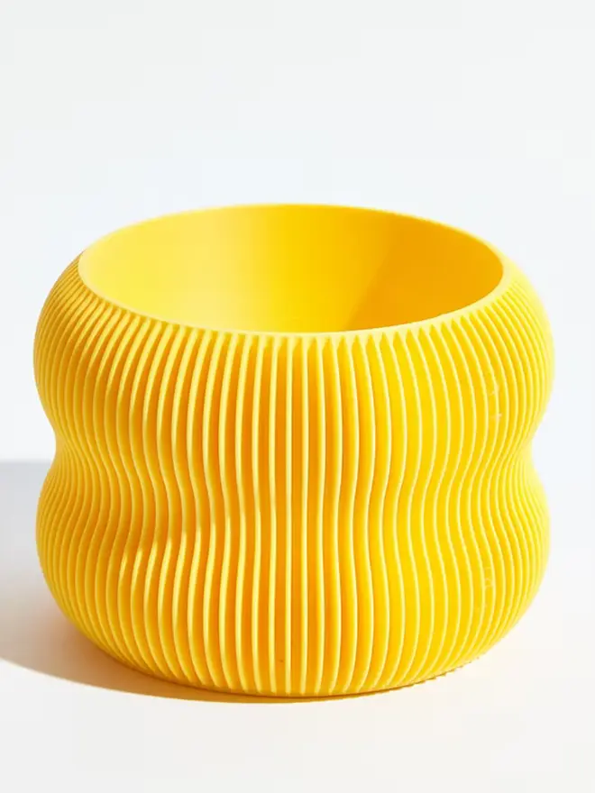 Sustainable 3D Printed Banana Yellow Plant Pot, bubble design, against a white background.